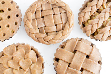 Female baker hands Making a Pie. Ingredients flat lay on kitchen table. Working with pastry or bakery cooking. Ready-to-bake pies