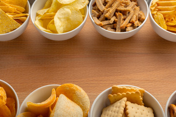Pretzels in bowls on wooden table from above