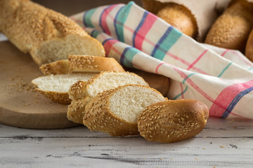 French baguette cut with a knife on cutting board