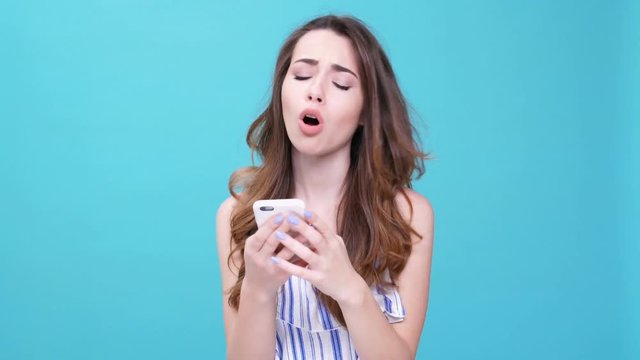 Young upset woman chatting on smartphone isolated