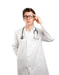 Confident doctor with concentration gesture against white background