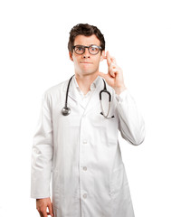 Hopeful doctor with finger cross gesture against white background