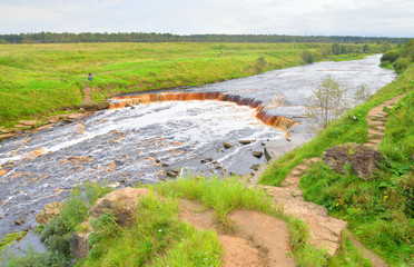 Fototapeta na wymiar Small waterfall on Tosna River.