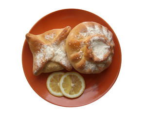 Two pies and lemon on a plate isolated