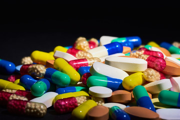 Medicine Pills. Tablets. Capsule.Pharmaceutical medicament, Close-up of pile of blue and green tablets - capsule. Pills and tablets on black background