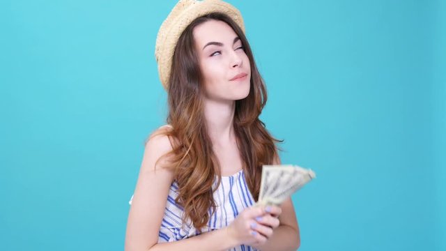 Young happy woman holding fan of money isolated