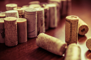Wine corks on wooden table background closeup photo.
