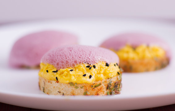 Spicy crostini filling eggs and vegetable foam