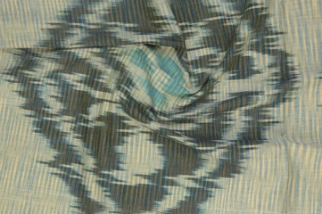 background of silk fabric with oriental ornaments. uzbek silk with ornament