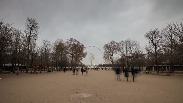 cloudy day ferris wheel tuileries garden crowded park panorama 4k time lapse france
