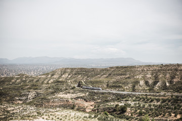 Fototapeta na wymiar Train crossing the mountain. Rocky landscape from the mountain. Landscape of Granada, Spain.