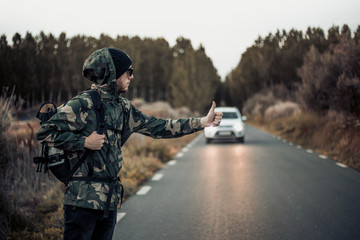 Man hitchhiking in the forest