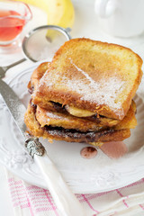 Chocolate banana french toast on a light background. Selective focus.