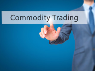 Commodity Trading - Businessman hand pressing button on touch screen interface.
