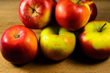 Pile of the apples on wooden table