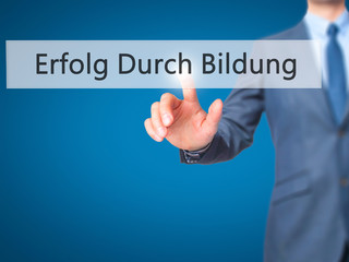 Erfolg Durch Bildung (Success Through Training in German) - Businessman hand pressing button on touch screen interface.