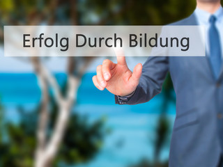 Erfolg Durch Bildung (Success Through Training in German) - Businessman hand pressing button on touch screen interface.