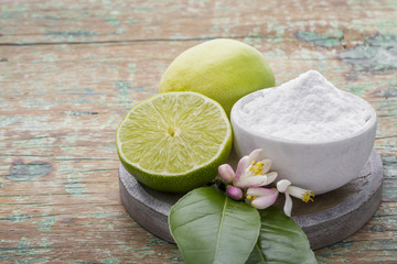 Baking soda with lemon on wooden background