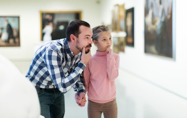 Father and daughter looking at expositions