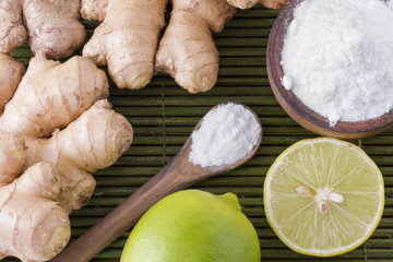 Baking soda with lemon on wooden background