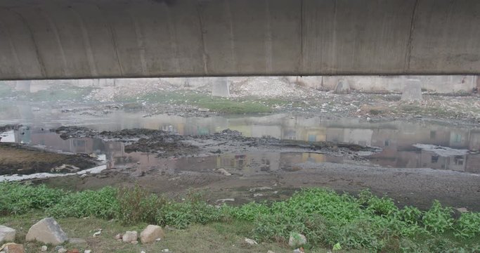 A river runs near Barapullah Elvated Road.