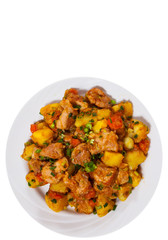 stewed meat with potatoes, onion and carrot. top view. isolated on white