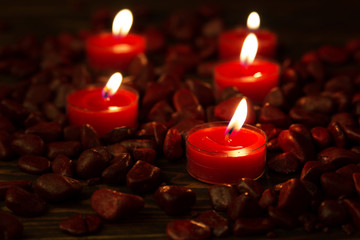 Red tea candles among decorative