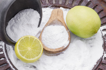 Baking soda with lemon on wooden background