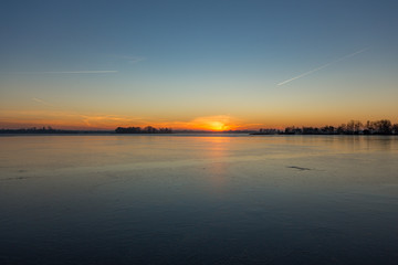 Sunrise over the frozen lakes in Loosdrecht the Netherlands
