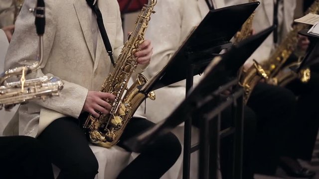 shot of Musicians is playing on saxophone in concert.