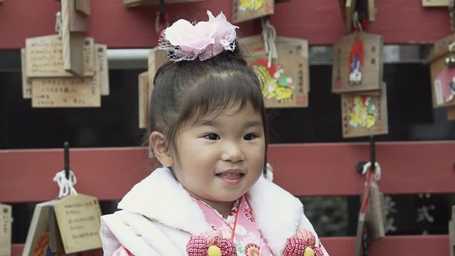 A three year old girl with her Mother dressed up in a Kimono to celebrate the Shichi-Go-San Festival