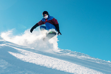 snowboarder is riding from snow hill