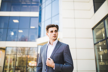 Successful business man outdoors in front of office building