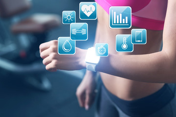 Young woman with fitness tracker in gym, closeup