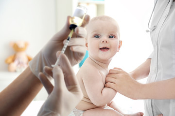 Doctor doing exercises with baby