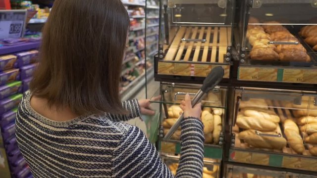 Woman buys pastry in supermarket