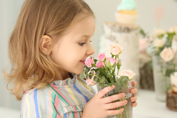 Cute little girl with flowers at party