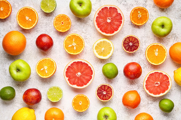 Citrus fruit pattern on white concrete table. Food background. Healthy eating. Antioxidant, detox, dieting, clean eating, vegetarian, vegan, fitness or healthy lifestyle concept