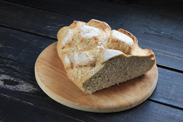 Fresh bread on a dark wooden table