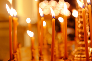 Charming lights of burning candles in church
