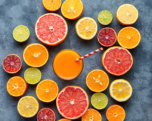 Juice with citrus fruit, grapefruit, orange on blue background. Top view, selective focus. Detox, dieting, clean eating, vegetarian, vegan, fitnes healthy concept