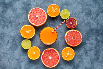 Juice with citrus fruit, grapefruit on blue background. Top view, selective focus. Detox, dieting, clean eating, vegetarian, vegan, fitnes healthy concept