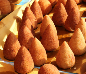lots of fried rice balls for sale in street food stall outdoors