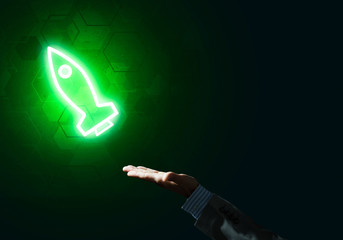 Man palm presenting Rocket web icon as technology concept