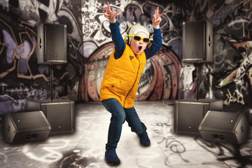 Boy dancing Hip-Hop . Children's fashion.The Young Rapper.Graffiti on the walls.Cool rap DJ. - obrazy, fototapety, plakaty