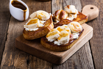 Breakfast ricotta toasts with  bananas and caramel