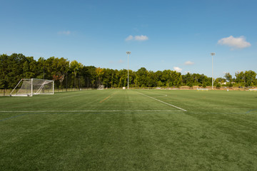 Soccer field background with a shallow depth of field on a beautiful summer day - Powered by Adobe
