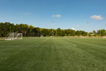 Soccer field background with a shallow depth of field on a beautiful summer day © clsdesign