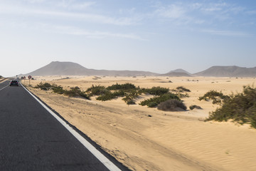 The asphalt  road through the sand dunes in Canarian Island