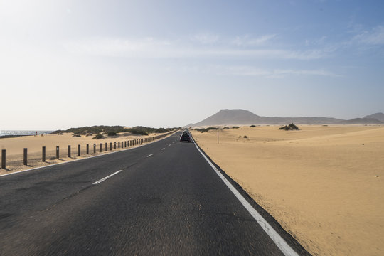 The asphalt  road through the sand dunes in Canarian Island